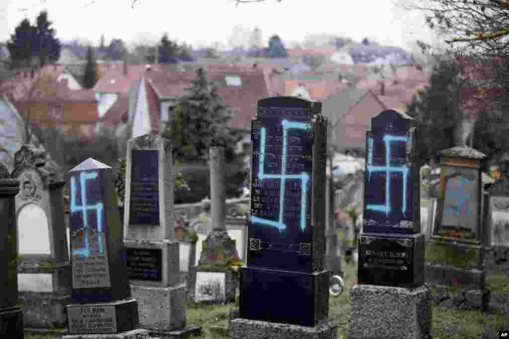 Tombs are vandalized in the Jewish cemetery of Quatzenheim, eastern France. Marches and gatherings against anti-Semitism are taking place across France following a series of anti-Semitic acts that shocked the country.