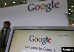 FILE - Security personnel answer a call at the reception counter of the Google office in the southern Indian city of Hyderabad.