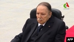 FILE - A picture from video footage broadcast by Algeria's "Canal Algerie" on July 5, 2016 shows wheelchair-bound President Abdelaziz Bouteflika visiting El-Alia cemetery where independence fighters are buried in an eastern Algiers suburb.