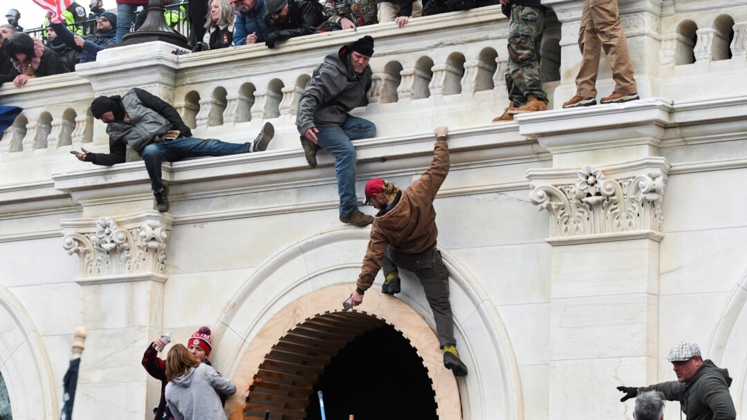 Supporters of U.S. President Donald Trump climb on walls at the U.S. Capitol during a protest against the certification of the 2020 U.S. presidential election results by the U.S. Congress, in Washington, U.S., January 6, 2021. REUTERS/Stephanie Keith