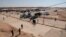 FILE - Iraqi security forces prepare to open the crossing between the Iraqi town of Qaim and Syria's Boukamal, in Qaim, Iraq, on Sept. 30, 2019. Overnight airstrikes near the crossing on Dec. 30, 2023, reportedly killed six Iran-backed militants.