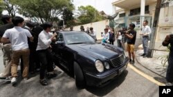 Media chases a car which came out from North Korean Embassy in Kuala Lumpur, Malaysia, Feb. 22, 2017. 