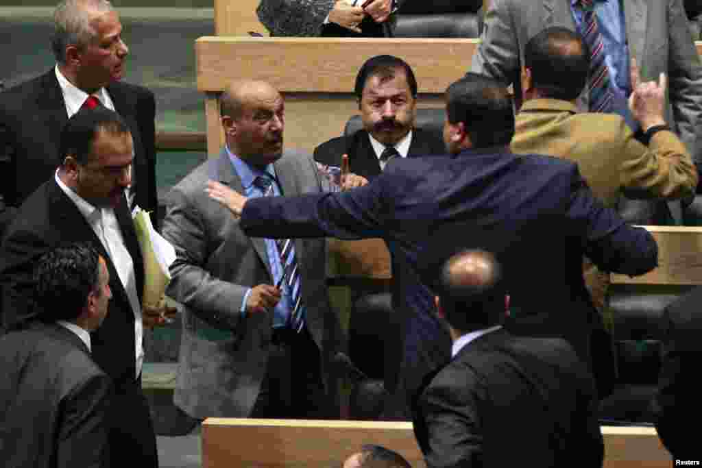 Members of the Jordanian House of Representatives confront each other during an altercation after Prime Minister Abdullah Ensour won a vote of confidence in Amman, Jordan.