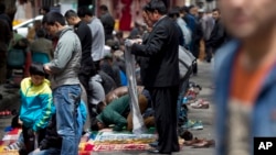 Ethnic Uighurs prepare for their Friday prayers outside a mosque in Urumqi, China's northwestern region of Xinjiang, Friday, May 23, 2014.