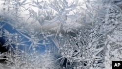 Ice crystals cover glass in Detroit, Monday, Jan. 21, 2019. Falling temperatures replaced the weekend's falling snow Monday as bitter cold and gusty winds swept across the eastern United States. (AP Photo/Paul Sancya)