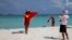 FILE - Chinese tourists take souvenir photos with the Chinese national flag as they visit Quanfu Island, one of Paracel Islands of Sansha prefecture of southern China's Hainan province in the South China Sea, Sept. 14, 2014. 