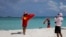 FILE - Chinese tourists take souvenir photos with the Chinese national flag as they visit Quanfu Island, one of Paracel Islands of Sansha prefecture of southern China's Hainan province in the South China Sea, Sept. 14, 2014. 