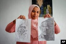 Somali artist Sana Ashraf Sharif Muhsin, 21, displays some of her drawings at her home in the capital Mogadishu, Somalia, Oct. 15, 2021.