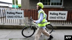 FILE - A voter leaves after casting his ballot in the European Elections, and in Ireland's Local Elections and the Divorce Referendum, being held concurrently, at a polling station at Drumcondra National school, in Dublin, May 24, 2019.