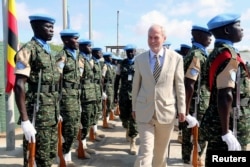 U.N. special representative for Somalia Nicholas Kay (C) inspects Ugandan peacekeeping troops during a ceremony at Mogadishu airport in Somalia, May 18, 2014.