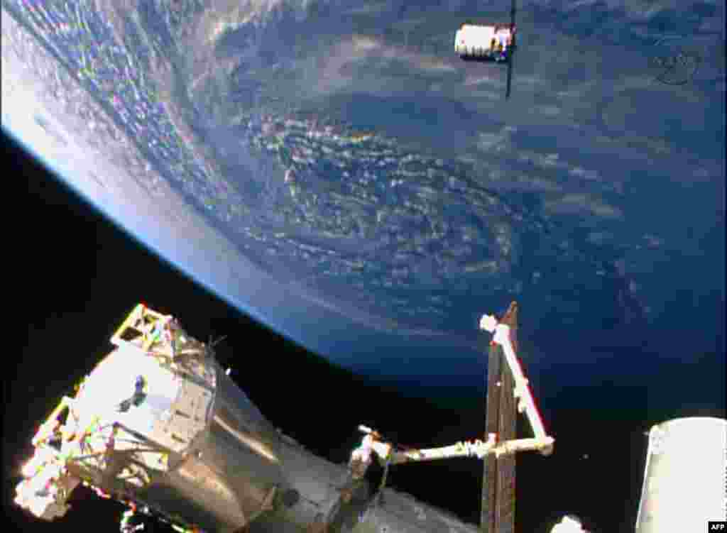 This NASA TV handout image shows the Orbital Sciences Corporation&#39;s unmanned Cygnus cargo ship arriving at the International Space Station on the company&#39;s first regular supply mission to the research outpost.