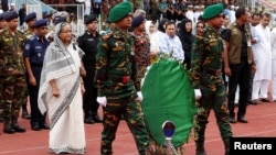 Bangladesh's Prime Minister Sheikh Hasina pays homage in front of the coffins of the victims who were killed in the attack on the Holey Artisan Bakery and the O'Kitchen Restaurant, during a memorial ceremony in Dhaka, July 4, 2016. 
