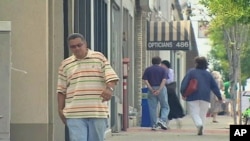 People walk down one of the main streets in Teaneck, New Jersey, where small businesses are having a rough go of it during this latest economic downturn, September 2011.