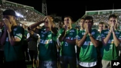 Chapecoense soccer players who did not travel with their team on a flight to Colombia, mourn during a tribute with fans to their late teammates in Chapeco, Brazil, Nov. 30, 2016. 