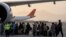 Warga asing memasuki pesawat Qatar Airways di bandara Kabul, Afghanistan, Kamis, 9 September 2021. (AP Photo/Bernat Armangue)