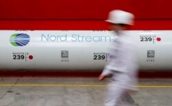 FILE - The logo of the Nord Stream 2 gas pipeline project is seen on a pipe at Chelyabinsk pipe rolling plant owned by ChelPipe Group in Chelyabinsk, Russia, Feb. 26, 2020.