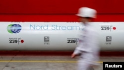 FILE - The logo of the Nord Stream 2 gas pipeline project is seen on a pipe at Chelyabinsk pipe rolling plant owned by ChelPipe Group in Chelyabinsk, Russia, Feb. 26, 2020. 
