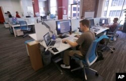 FILE- Workers at the Target Technology Innovation Center office in San Francisco.