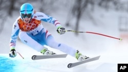 Austria's Matthias Mayer makes a turn in the men's downhill at the Sochi 2014 Winter Olympics, Feb. 9, 2014, in Krasnaya Polyana, Russia.