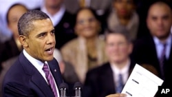 President Barack Obama holds up a proposed mortgage application form as he speaks at the James Lee Community Center in Falls Church, Va., Wednesday, Feb. 1, 2012.