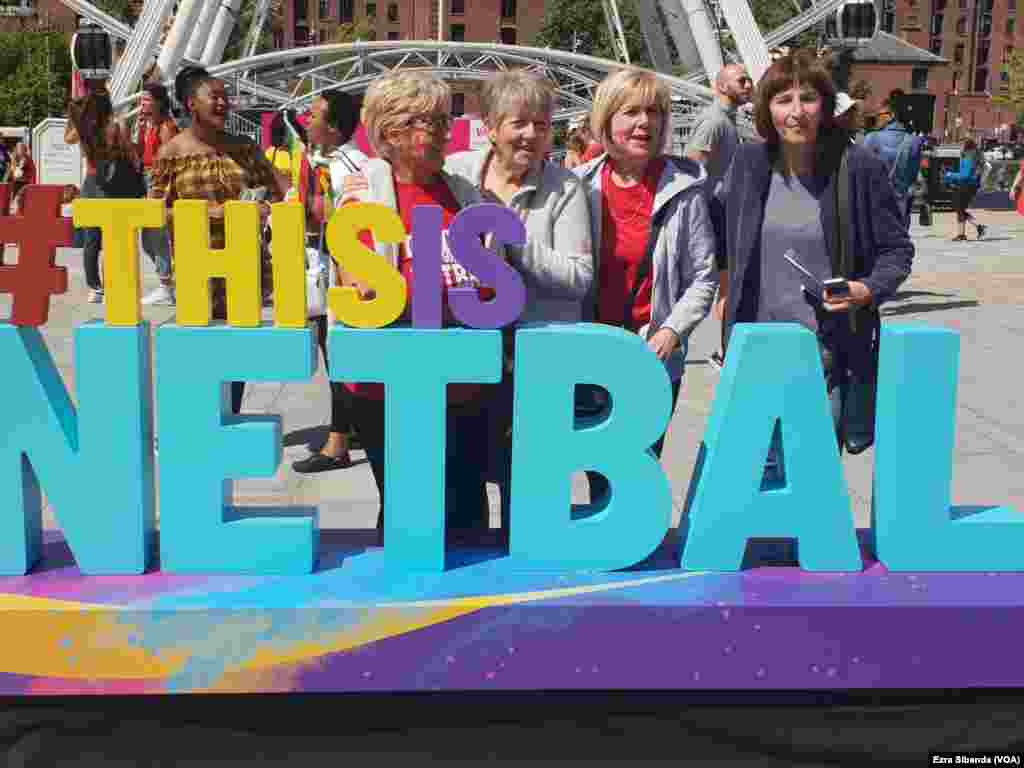 Netball fans standing by a "This is Netball" sign