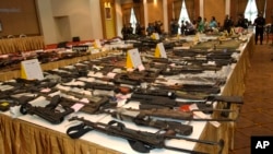 Weapons Thai military seized from raids from May 22 to June 25 are displayed during a news conference in Bangkok, Thailand, Sunday, June 29, 2014.