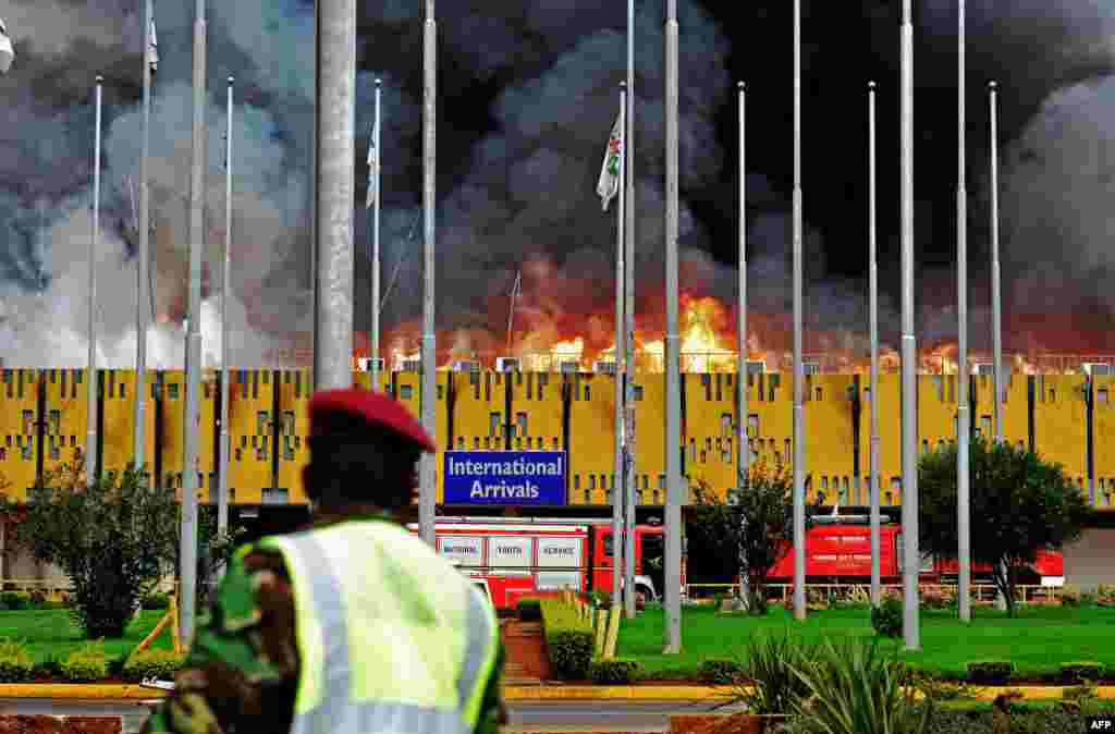 Flames and black smoke billow from the burning Jomo Kenyatta international airport, Nairobi, Kenya. A massive fire shut down Nairobi&#39;s international airport with flights diverted to regional cities as firefighters battled to put out the blaze in east Africa&#39;s biggest transport hub.