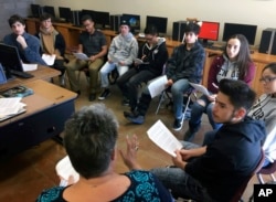 FILE - english and college-preparation teacher Rhonda Gardner, bottom, leads a discussion about how to adjust to the academic, financial and social pressures of collegiate life for high school seniors at the Academy for Technology and the Classics in San