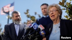 Auschwitz survivor Eva Schloss, stepsister of Holocaust diarist Anne Frank, talks to the media at Newport Harbor High School, March 7, 2019, after speaking with a group of students seen in viral online photos giving Nazi salutes over a swastika, in Newport Beach, Calif.