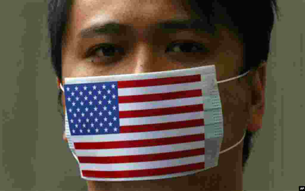 A supporter of WikiLeaks founder Julian Assange wears the mask featuring the American National flag during a protest at Consulate General of the United States in Hong Kong Friday. (Kin Cheung/AP)
