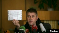 FILE - Vyacheslav Ponomaryov, separatist mayor of Slovyansk in eastern Ukraine, holds up a referendum ballot.