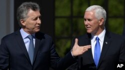 U.S. Vice President Mike Pence, right, walks with Argentina's President Mauricio Macri at the government residence in Buenos Aires, Argentina, Aug. 15, 2017. 