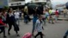 FILE - Venezuelans leave their country as they make their way to the Simon Bolivar international bridge in San Antonio del Tachira, Venezuela, on the border with Colombia, Feb. 21, 2019. 