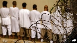 Detainees stand during an early morning Islamic prayer at the U.S. military prison in Guantanamo Bay, Cuba (2009 file photo)