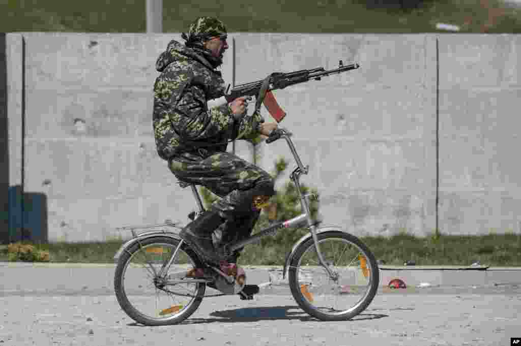 A Ukrainian serviceman rides a bicycle in Shyrokyne, eastern Ukraine.