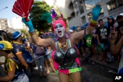 A reveler in costume attends the Banda de Ipanema carnival "bloco" parade in Rio de Janeiro, Brazil, Feb. 11, 2017. Merrymakers take to the streets in hundreds of open-air "bloco" parties ahead of Rio's over-the-top Carnival.
