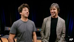 FILE - In this Sept. 2, 2008, photo, Google co-founders Sergey Brin, left, and Larry Page talk during a new conference at Google Inc. headquarters in Mountain View, California. Like many startups, Google reportedly started in a garage. 