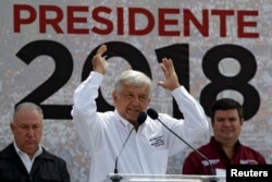 FILE - Front-runner Andres Manuel Lopez Obrador of the National Regeneration Movement gestures while addressing supporters during a campaign rally in Nuevo Laredo, Mexico, April 5, 2018.