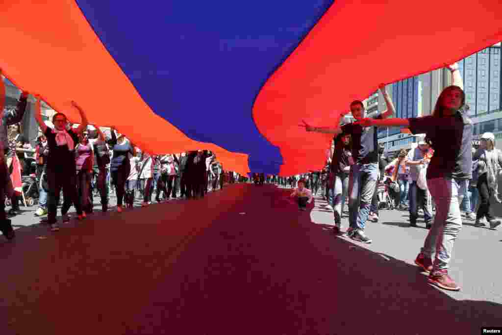 Lebanese Armenians carry an Armenian national flag as they march in North Beirut, April 24, 2015.