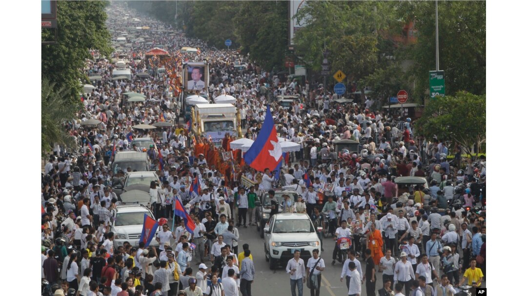 FILE - Cambodia mourners march during a funeral procession of Cambodia prominent political analyst Kem Ley in Phnom Penh, Cambodia, July 24, 2016. Tens of thousands of Cambodians marched in the procession for the leading government critic who was fatally shot.