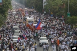 FILE - Cambodia mourners march during a funeral procession of Cambodia prominent political analyst Kem Ley in Phnom Penh, Cambodia, July 24, 2016. Tens of thousands of Cambodians marched in the procession for the leading government critic who was fatally shot.