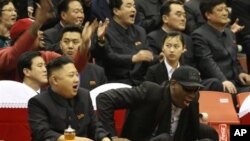 North Korean leader Kim Jong Un, left, and former NBA star Dennis Rodman watch North Korean and U.S. players in an exhibition basketball game, Pyongyang, Feb. 28, 2013.