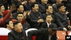 North Korean leader Kim Jong Un, left, and former NBA star Dennis Rodman watch North Korean and U.S. players in an exhibition basketball game, Pyongyang, Feb. 28, 2013.