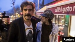 German-Turkish journalist Deniz Yucel and his wife, Dilek Mayaturk Yucel, are pictured in front of their home after Deniz Yucel was released from prison in Istanbul, Turkey, Feb. 16, 2018.