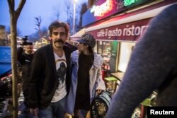 FILE - German-Turkish journalist Deniz Yucel and his wife, Dilek Mayaturk Yucel, are pictured in front of their home after Deniz Yucel was released from prison in Istanbul, Turkey, Feb. 16, 2018.