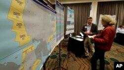 Areas that could potentially be leased for offshore oil and gas drilling are shown in yellow on a map displayed at an open house hosted by the federal Bureau of Ocean Energy Management to provide information and gather public comment on the Trump administration's proposal to expand offshore oil drilling off the Pacific Northwest coast, March 5, 2018.
