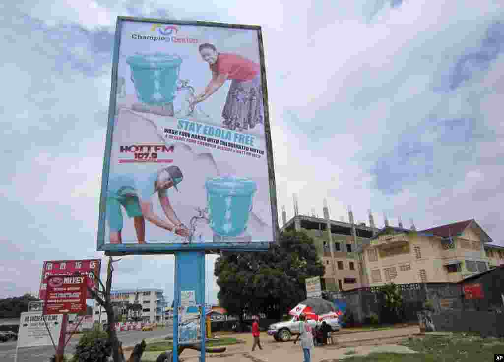 A large billboard promotes the washing of hands to prevent the spread of the deadly Ebola virus in Monrovia, Liberia, Aug. 9, 2014.