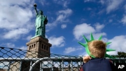 A young visitor looks up at "Lady Liberty"