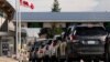 FILE - People at the U.S.-Canadian border in Blaine, Washington, U.S., Aug. 9, 2021.