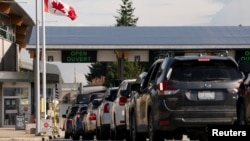FILE - People at the U.S.-Canadian border in Blaine, Washington, U.S., Aug. 9, 2021.